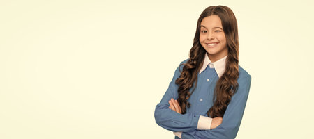 express positive emotions. face skincare. winking kid with curly hair. beauty and fashion. Child face, horizontal poster, teenager girl isolated portrait, banner with copy space.の写真素材