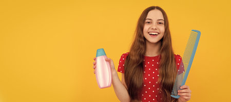 hairdresser. girl has wavy hairdo hold hairbrush. teen beauty hairstyle. frizz child portrait. Kid girl hair care, horizontal poster. Banner header with copy space.の写真素材