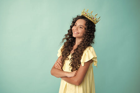 Happy teenager. Girls birthday party, funny kid in crown. Imagine herself a queen, child wear diadem. Successful teenager wear luxury beauty queen crown, success.の写真素材
