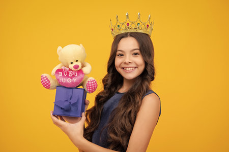 Girls birthday party, funny kid in crown. Imagine herself a queen, child wear diadem. Successful teenager wear luxury beauty queen crown, success. Happy girl face, positive and smiling emotions.の写真素材