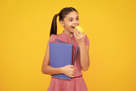 Teenager school girl with books isolated studio background. Happy teenager, positive and smiling emotions of teen girl.の写真素材