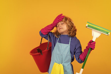 Child mopping house, cleaning home. Detergents and cleaning accessories. Cleaning service. Little boy housekeeping.の写真素材