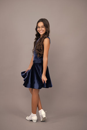 Happy girl face, positive and smiling emotions. Full length of teenager child wearing ball dress.の写真素材