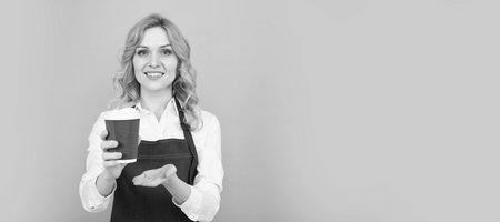 take it. take away beverage. cheerful girl drinking tea. woman in apron with plastic cup. Woman isolated face portrait, banner with mock up copy space.の写真素材