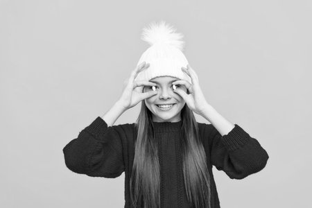 funny child in winter hat with pill, food additivesの写真素材