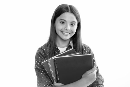 Teenager school girl with books isolated white studio background. Portrait of happy smiling teenage...