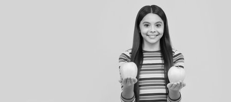 As fresh as fruit. Happy girl hold apples. Child nutrition. Childs diet. Eat enough fruit. Child girl portrait with apple, horizontal poster. Banner header with copy space.の写真素材