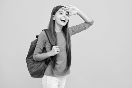 School teen girl in with backpack. Teenager student on isolated background. Kids learning, education, studying and knowledge. Excited teenager, glad amazed and overjoyed emotions.の写真素材