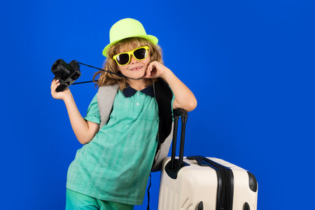 Child with travel suitcase on vacation. Kids travel and adventure concept.の写真素材
