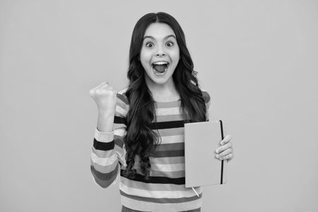 Amazed teenager. Schoolgirl with copy book posing on isolated background. Literature lesson, grammar...