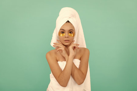 teen girl in shower towel with golden patch. cosmetologyの写真素材