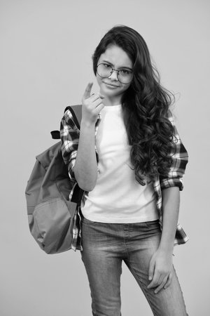 Unhappy sad teenager schoolgirl. School teen girl in with backpack. Teenager student on isolated background. Kids learning, education, studying and knowledge.の写真素材