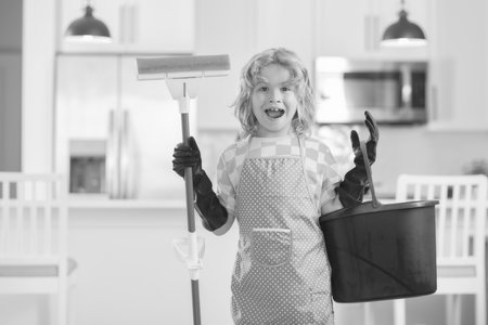 Portrait of child helping with housework, cleaning the house. Housekeeping, home chores.の写真素材