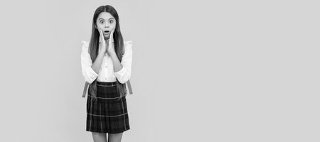 kid in uniform on yellow background. september 1. childhood. Horizontal isolated poster of school girl student. Banner header portrait of schoolgirl copy space.の写真素材