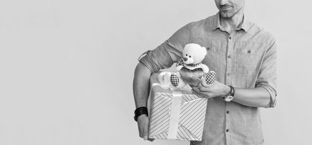 cropped mature man hold box and toy on yellow background, copy space, anniversaryの写真素材