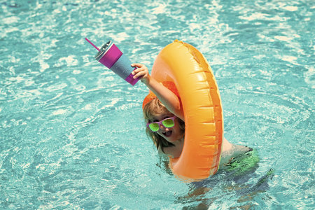 Boy swimming and playing in a pool. Child playing in swim pool. Summer vacation concept. Summer kids...
