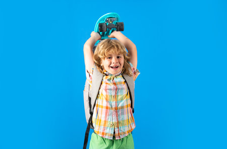 Kid with skateboard over isolated blue background.の写真素材