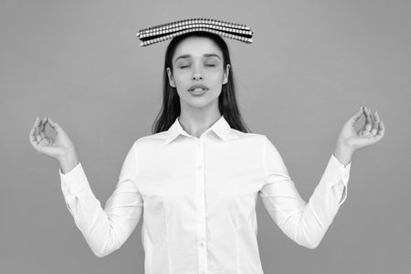 Young student girl in casual clothes, isolated on gray background studio portrait. Hold notebooks. Cheerful young attractive student woman.の写真素材