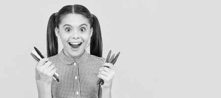 amazed teen girl hold colorful markers office supplies for painting, creative mind. Portrait of schoolgirl student, studio banner header. School child face, copyspace.の写真素材