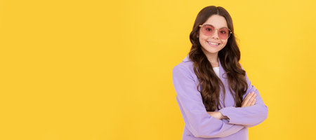 beautiful happy teen girl with curly hair in stylish purple jacket and sunglasses, fashion model. Child face, horizontal poster, teenager girl isolated portrait, banner with copy space.の写真素材