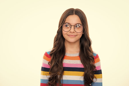 Thinking face, thoughtful emotions of teenager girl. Emotional portrait of caucasian teenager child girl isolated on studio white background.の写真素材