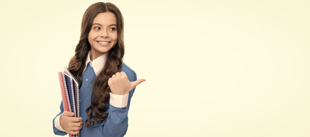 high school education. schoolkid with copybook. happy teen girl with notebook. Portrait of schoolgirl student, studio banner header. School child face, copyspace.の写真素材