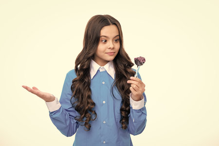 Teenager girl with caramel candies on sticks. Child with lollipops.の写真素材