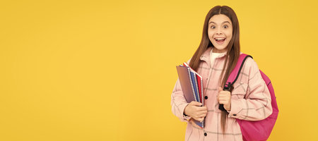surprised child girl wear pink checkered shirt carry school bag and notebooks, study. Portrait of school girl student, studio banner header. School child pupil face, copy space.の写真素材