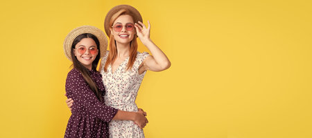 Mother and daughter kid banner, copy space, isolated background. mother and daughter smile in straw hat on yellow background.の写真素材
