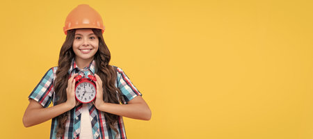 Architect teenager girl. renovation work. time to renovate. deadline extended. early morning. Child builder in helmet horizontal poster design. Banner header, copy space.の写真素材