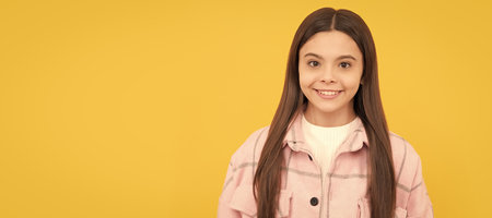 happy teen girl wear pink checkered shirt, casual. Child face, horizontal poster, teenager girl isolated portrait, banner with copy space.の写真素材