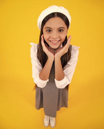 Happy face, positive and smiling emotions of teenager girl. Cute preteen girl head shot. Child portrait on isolated background. Beautiful teenager face.の写真素材