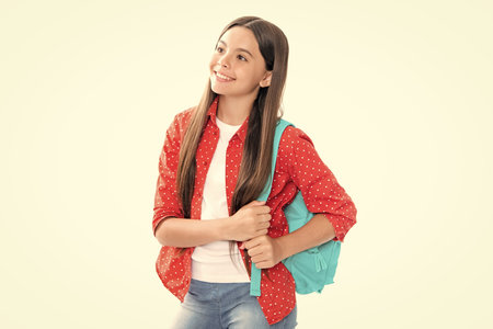 School and education concept. Back to school. Schoolchild, teenage student with backpack, isolated, copy space. Portrait of happy smiling teenage child girl.の写真素材
