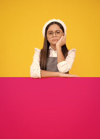 Teenage girl holds a blank for notification informing. Advertisement and sale. Blank board for copy space. Angry face, upset emotions of teenager girl.の写真素材