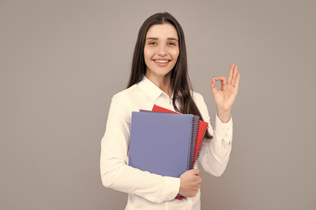 Student education in high school university college concept. Happy young girl holding notebooks.の写真素材