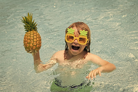 Summer vacation. Cute kid in swimming pool. Children play in tropical resort. Family beach vacation and summer activity.の写真素材