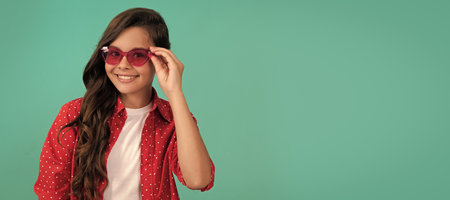 pretty look of young girl. portrait of child casual style on blue background. Child face, horizontal poster, teenager girl isolated portrait, banner with copy space.の写真素材
