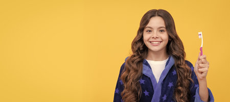 healthy smile. smiling kid doing morning routine. dental care. Banner of child girl with teeth brush, studio portrait, header with copy space.の写真素材