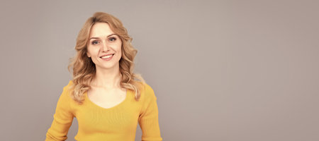 cheerful blonde beauty woman with curly hair, beauty. Woman isolated face portrait, banner with mock up copy space.の写真素材
