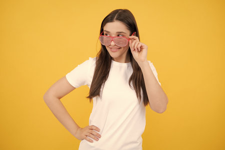 Surprised woman, shocking girl wearing funny glasses on isolated yellow background, Wow face feelings with copy space for advertising.の写真素材