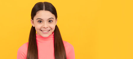 cheerful kid with long hair. beauty and fashion. female fashion model. Child face, horizontal poster, teenager girl isolated portrait, banner with copy space.の写真素材
