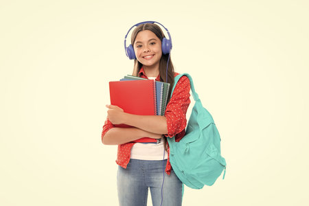 Back to school. Full length of teenager school girl with backpack hold aplle ready to learn. School children with school bag on isolated white studio background. Portrait of happy smiling child girl.の写真素材