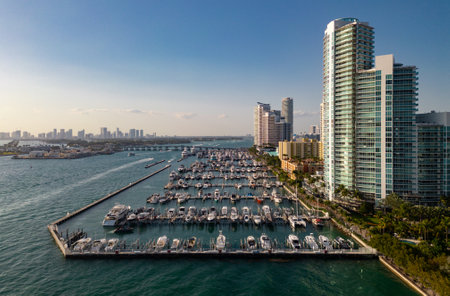 Aerial view of Miami marina with luxury yachts and tropical skyline. Miami beach. Sailboats and...
