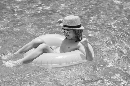 Happy child enjoying summer vacation outdoors in the water in the swimming pool.の写真素材