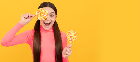 lollipop child. kid with long hair hold lollypop. sugar candy on stick. caramel candy shop. Teenager child with sweets, poster banner header, copy space.の写真素材