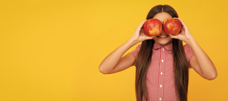 vitamin and dieting. child eating healthy food. childhood health. natural organic fresh apple. Child girl portrait with apple, horizontal poster. Banner header with copy space.の写真素材
