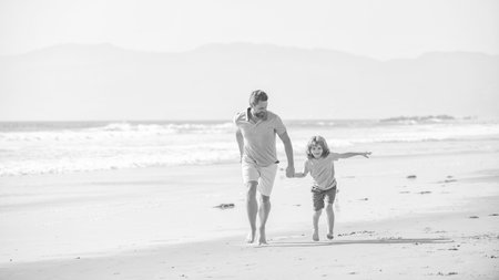 daddy with kid boy on summer day. dad and child having fun outdoors. childhoodの写真素材