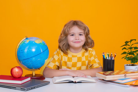 School and education concept. Portrait of cute child school boy, isolated on yellow background. Back...