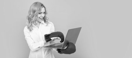 Woman isolated face portrait, banner with mock up copy space. ceo watching championship. woman boss punch laptop in boxing gloves. anger management.の写真素材