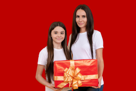 Mother and daughter with gift, . Gift for Birthday or Valentines Day. Gift for Mothers Day or Womens Day. Gift for mother. Happy daughter with gifts. Holiday with mom and child. Celebrate with gifts.の写真素材